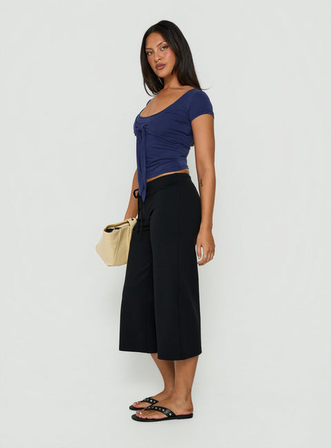 Featuring Kallora Low Rise Wide Leg Capris Black womens-regular-pants front view of model wearing Princess Polly