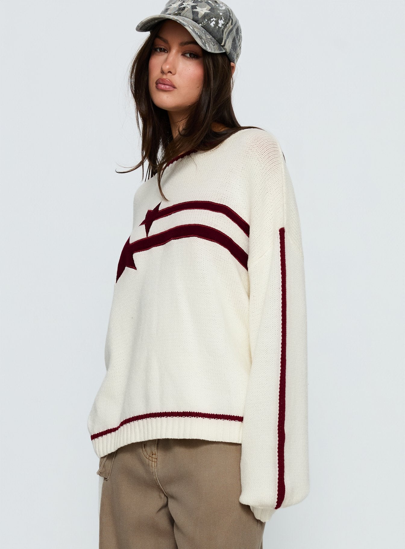 side view of model wearing Princess Polly Star Track Graphic Jumper Cream / Red Longline Jumpers 