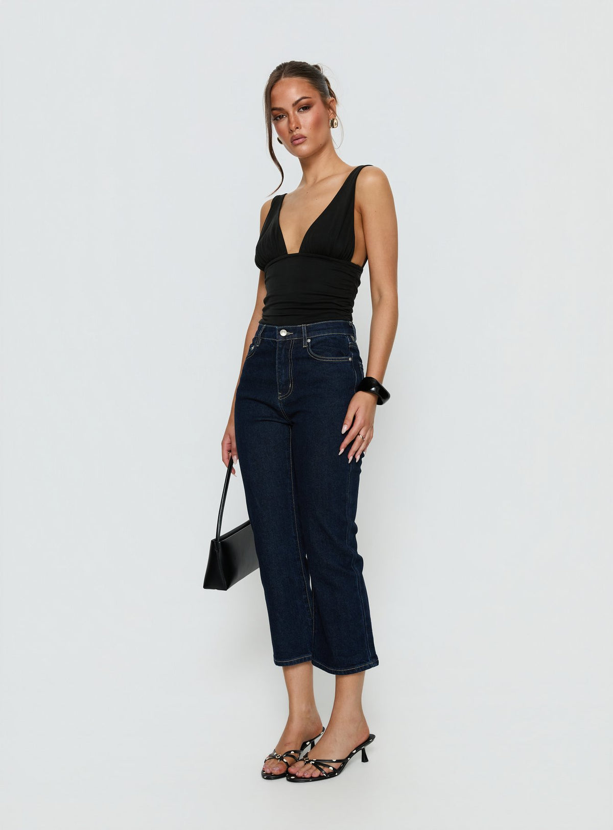 side view of model wearing Princess Polly Cindee High Rise Cropped Jeans Raw Indigo High Rise Jeans 