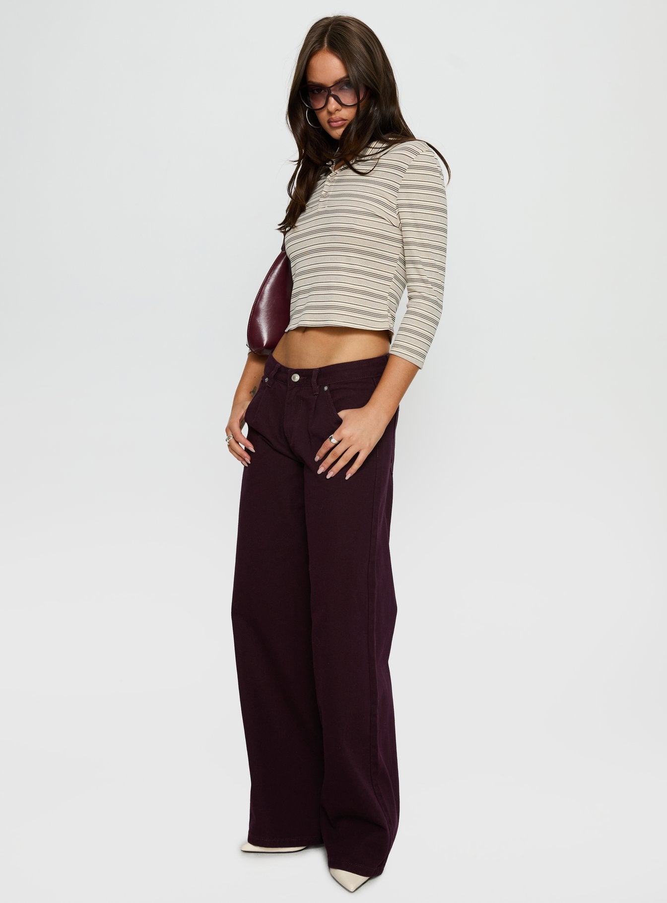side view of model wearing Princess Polly Supercut Low Rise Baggy Pleat Jeans Currant Mid Rise Jeans 