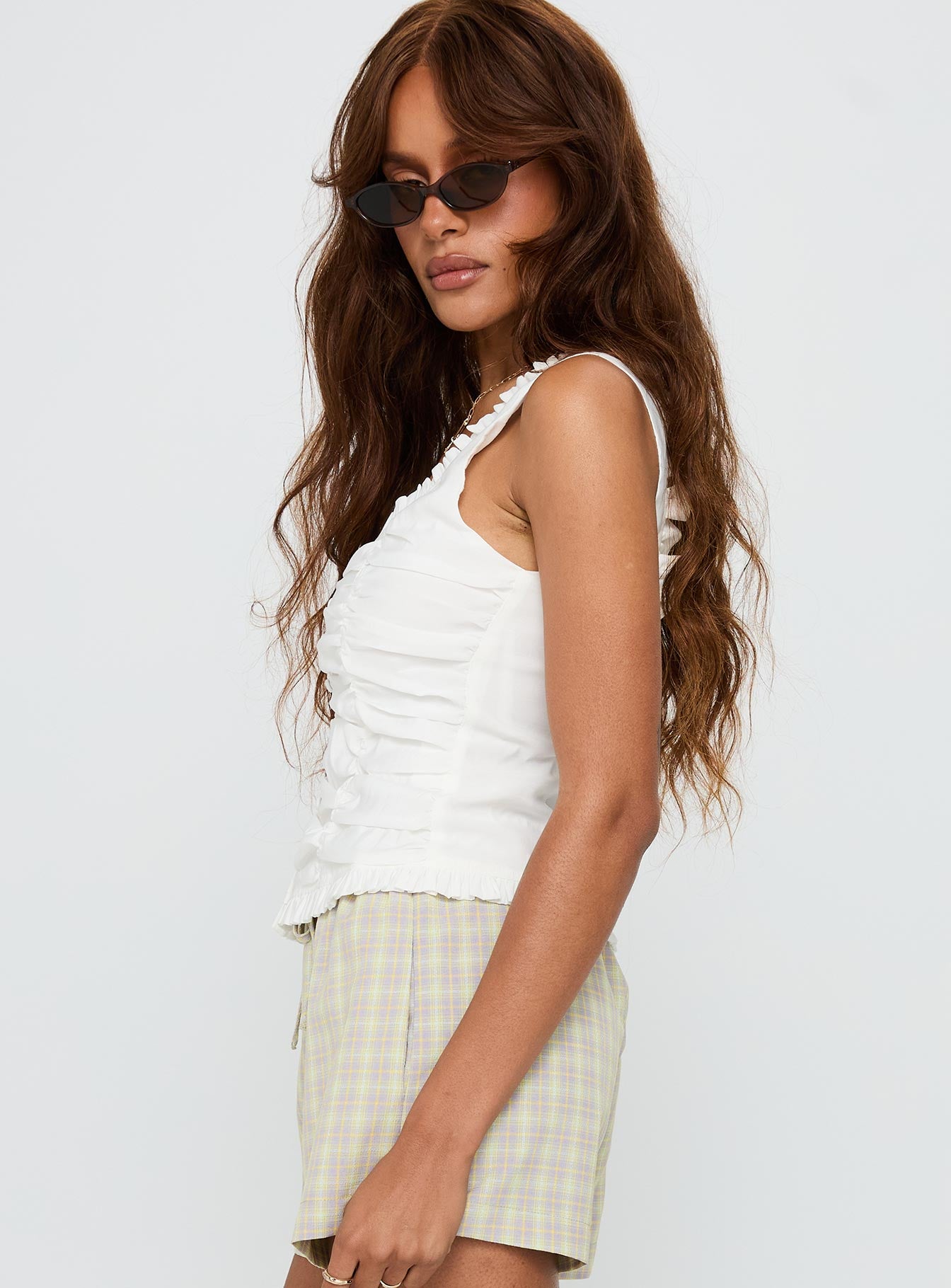 side view of model wearing Princess Polly Almeda Button Up Top White Sleeveless Scoop Neck 