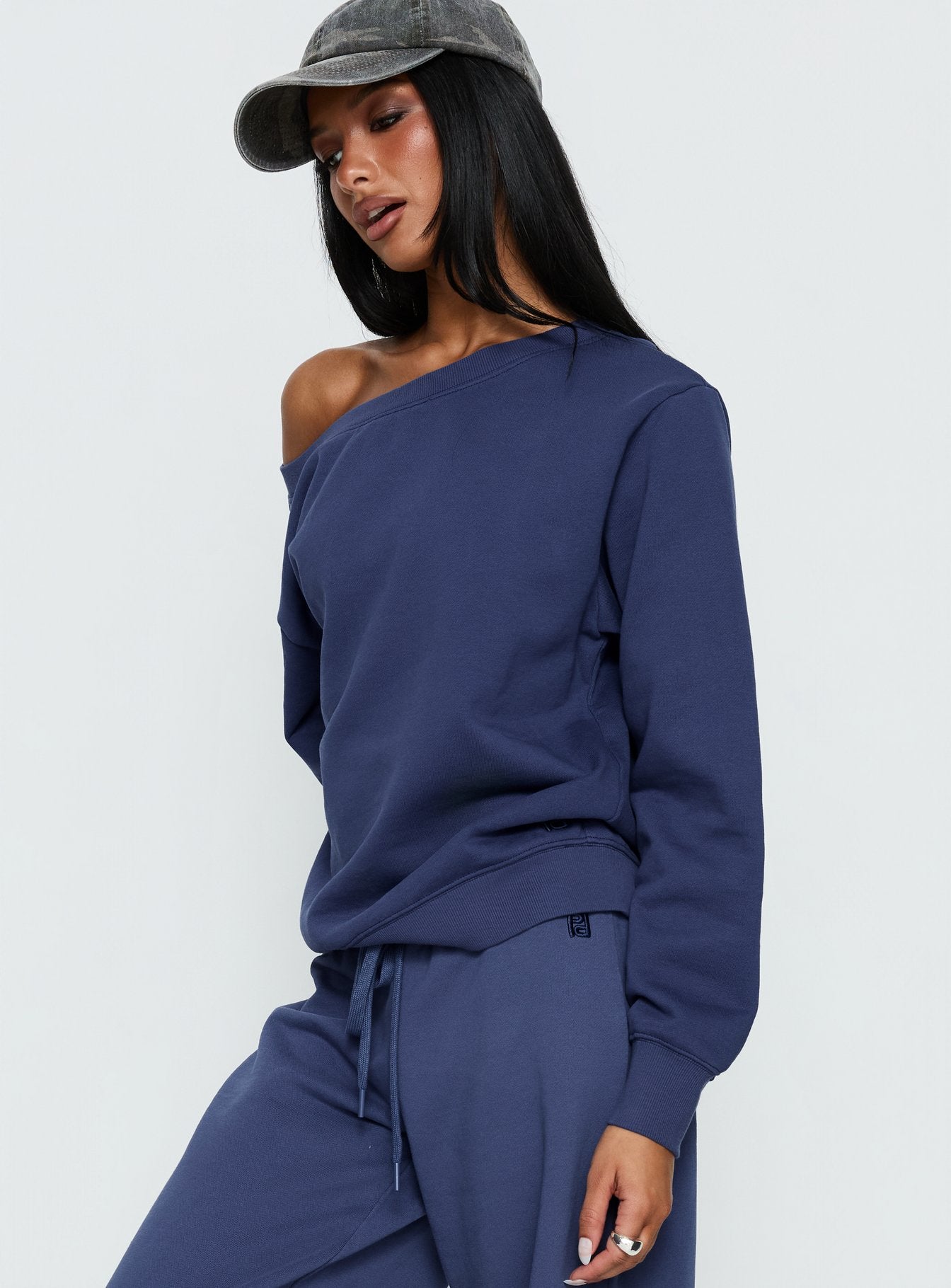 side view of model wearing Princess Polly Wellness Off the Shoulder Jumper Navy 