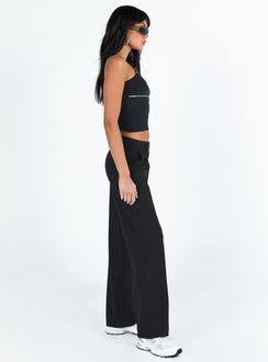 side view of model wearing Princess Polly Archie Low Rise Pants Black Petite Mid Rise 