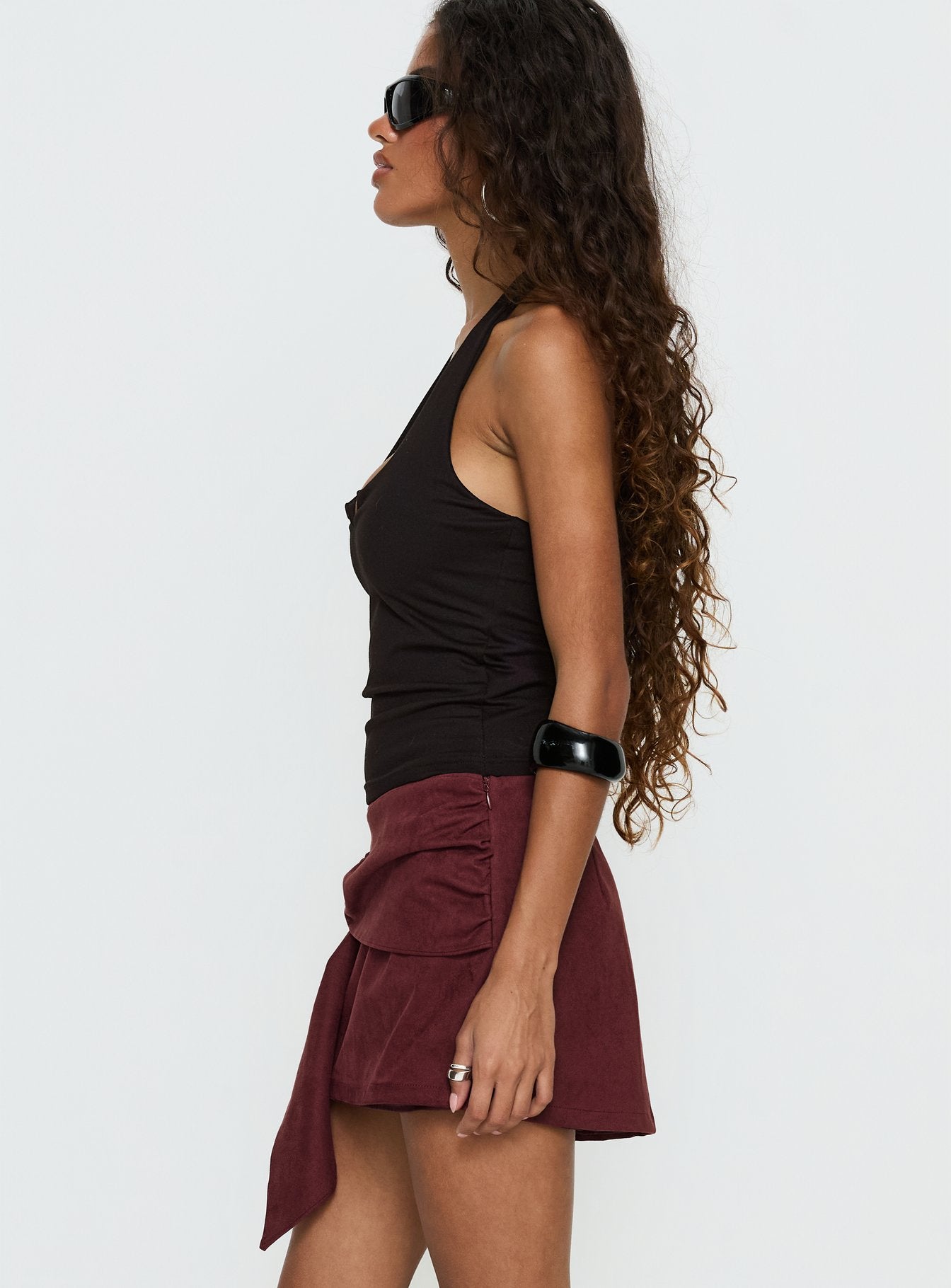   side view of model wearing Princess Polly Lowretta Faux Suede Belt Mini Skirt Burgundy Mini Skirts 