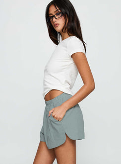 side view of model wearing Princess Polly Fealure Shorts Green High Waisted Shorts 