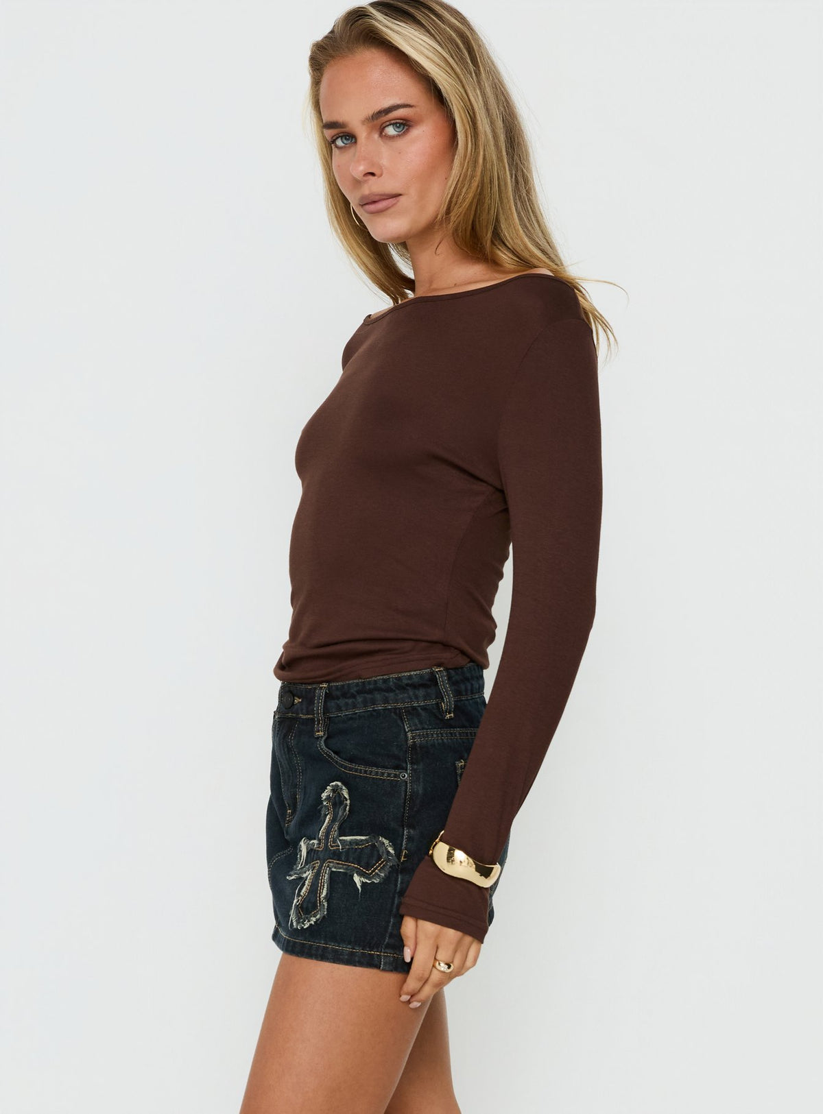 Presenting the Barracuda Applique Denim Mini Skirt Grunge Wash womens-skirts side view of model wearing Princess Polly