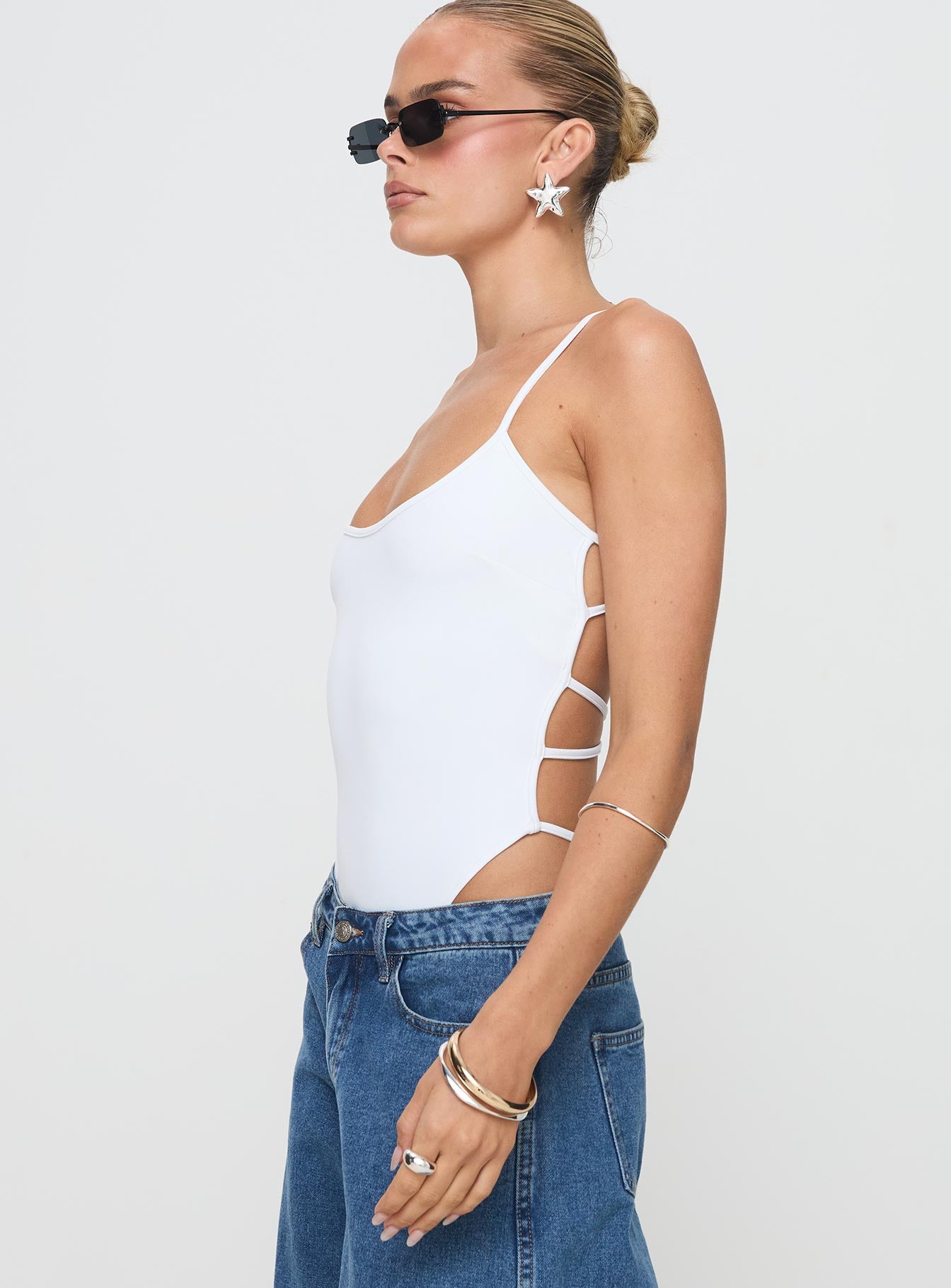side view of model wearing Princess Polly All Tied Up Bodysuit White Tall Sleeveless 