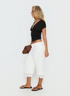 side view of model wearing Princess Polly Basma Bloomer Trouser Pants Rayon White Mid Rise Pants 