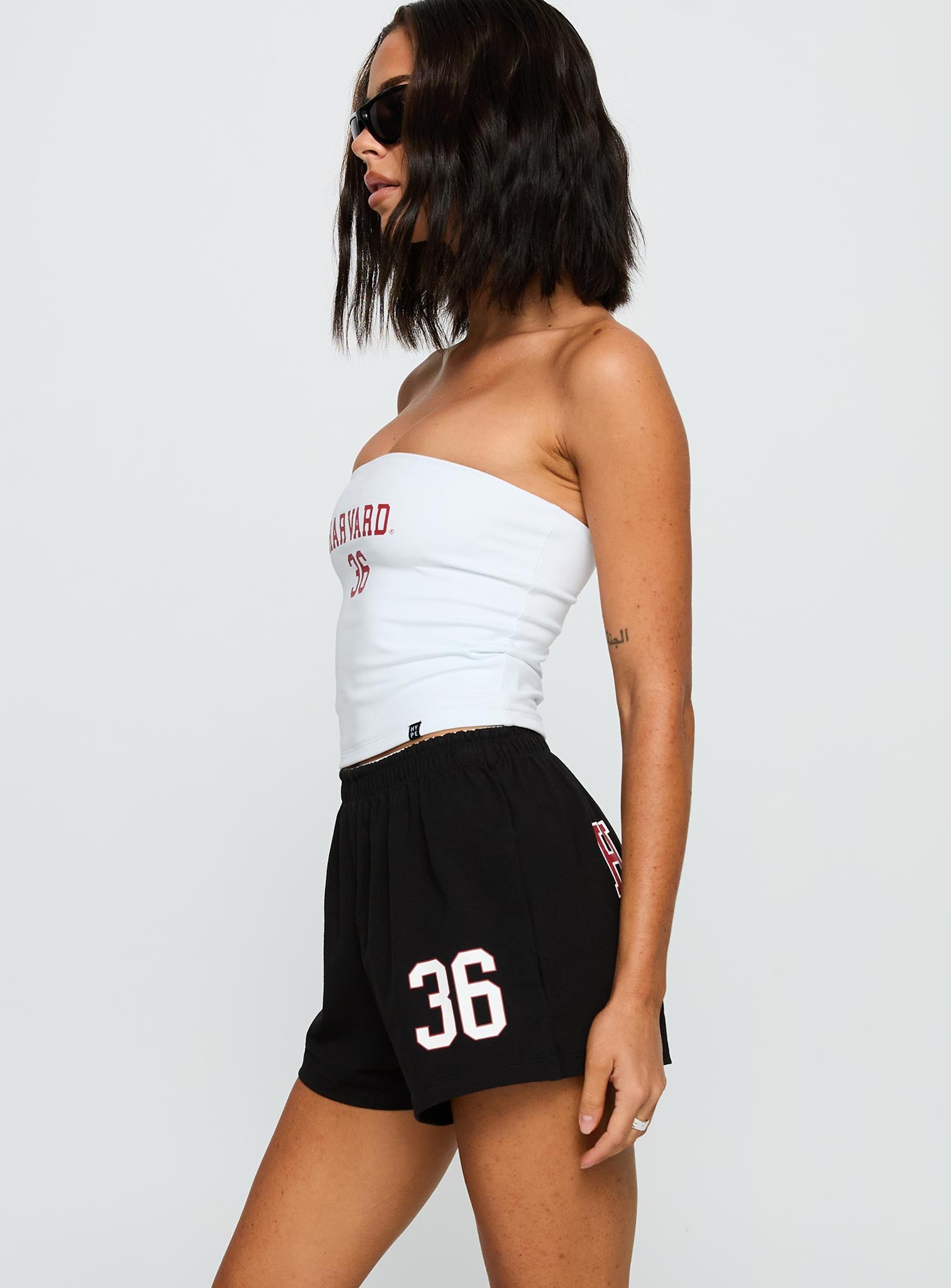 side view of model wearing Princess Polly Harvard Soffee Shorts Black High Waisted Shorts 
