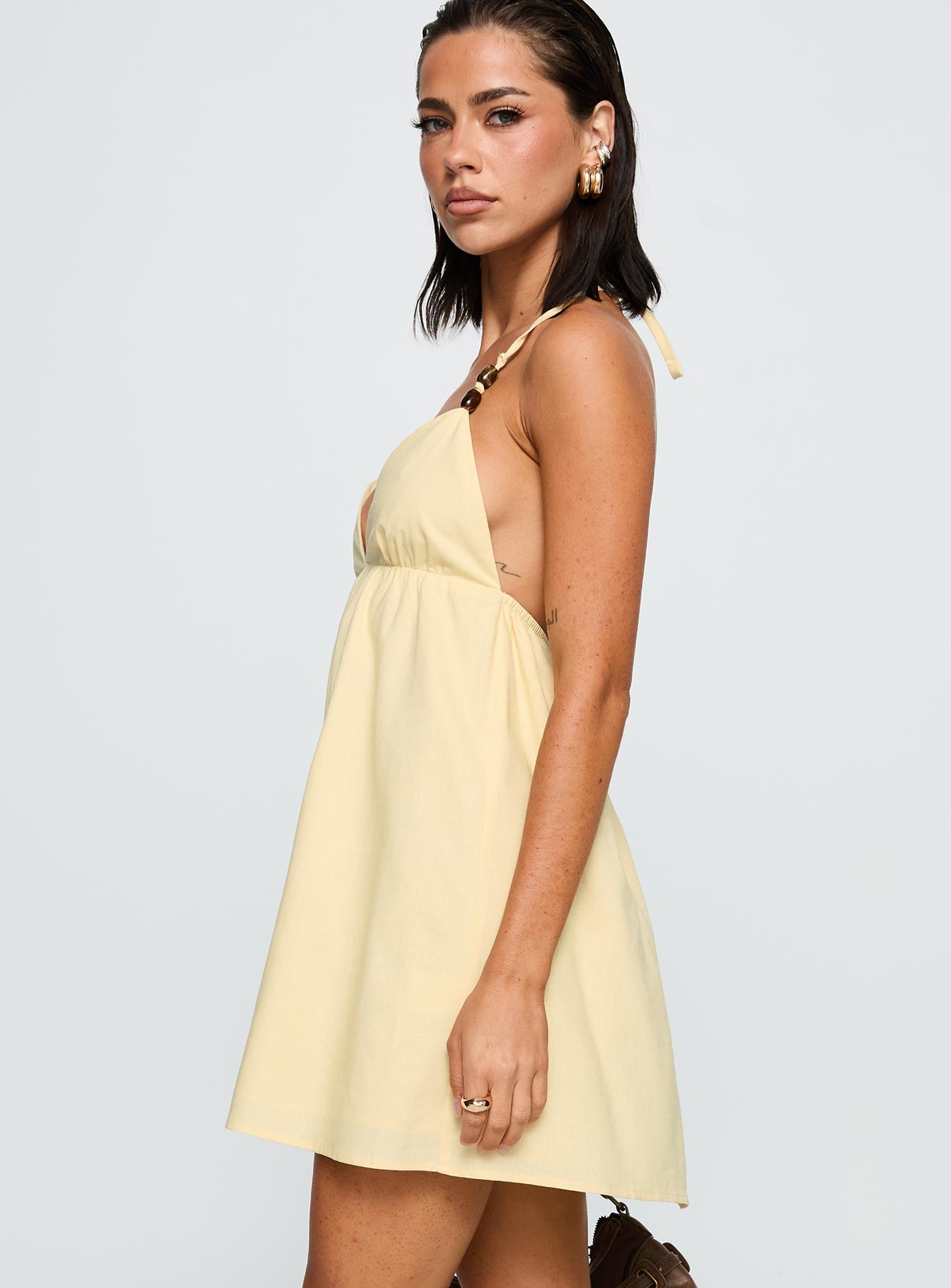 side view of model wearing Princess Polly Melanea Mini Dress Yellow Plunger 
