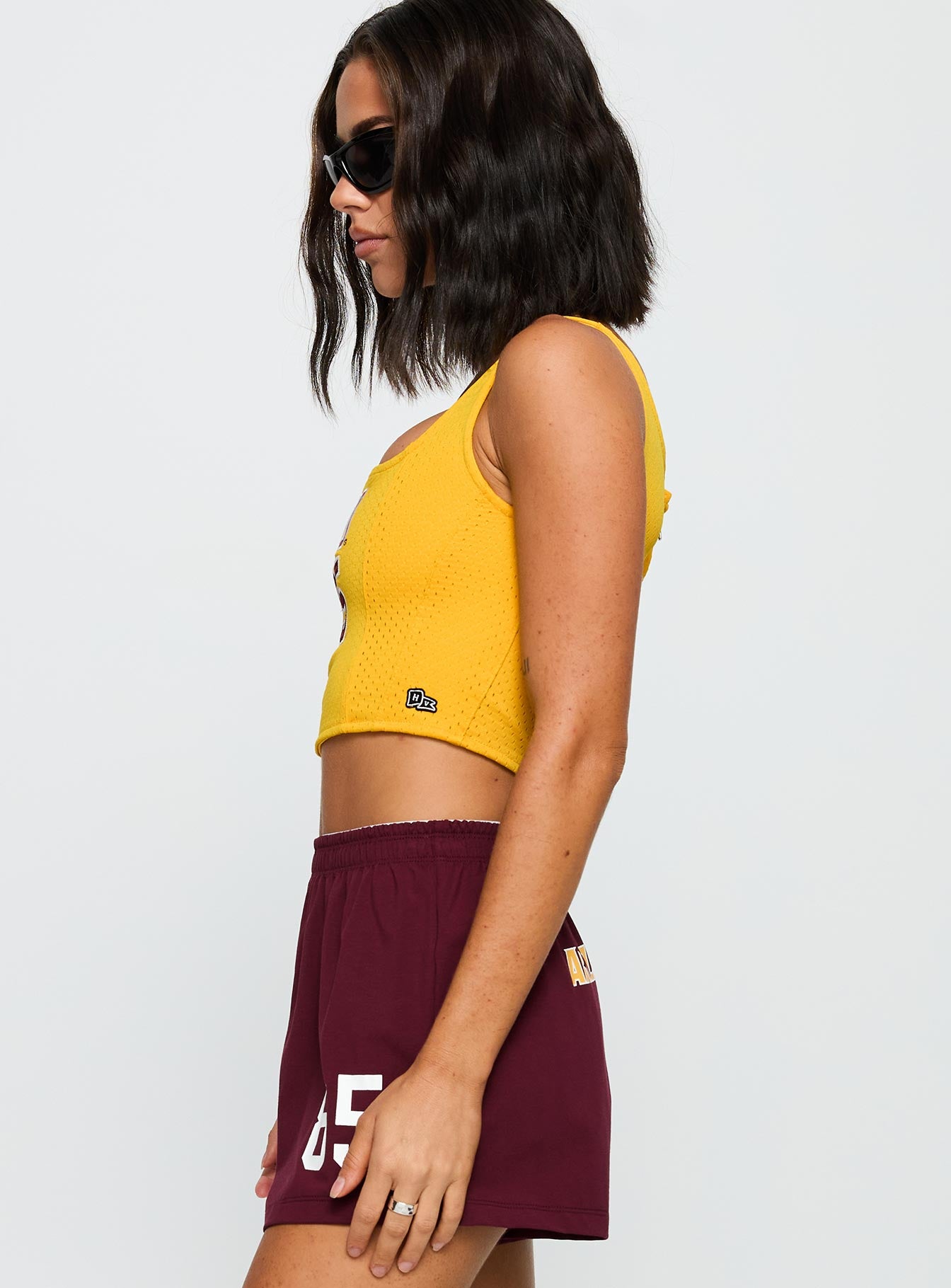 side view of model wearing Princess Polly ASU Soffee Shorts Maroon High Waisted Shorts 
