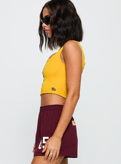 side view of model wearing Princess Polly ASU Soffee Shorts Maroon High Waisted Shorts 