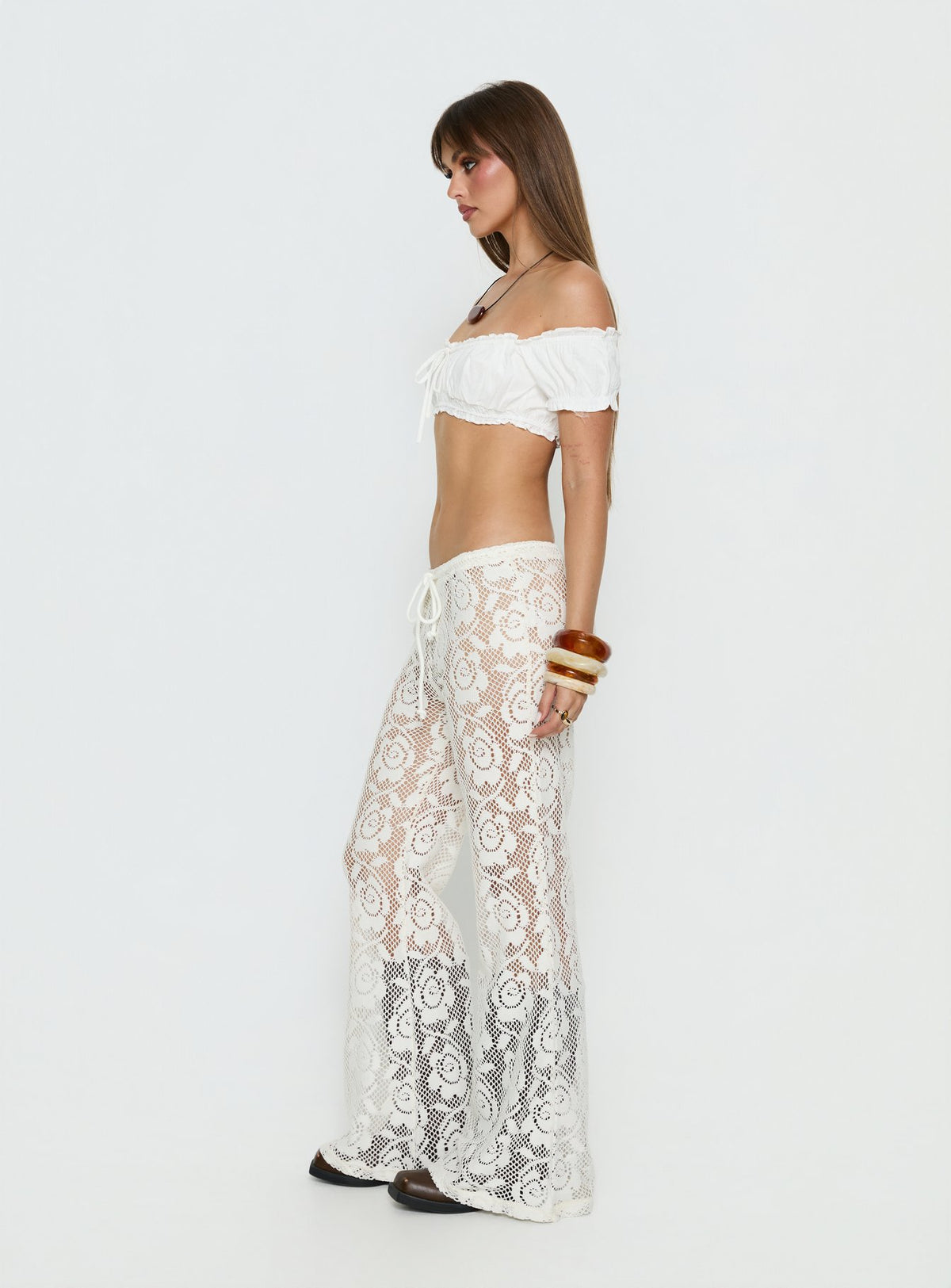 side view of model wearing Princess Polly Rosadonna Lace Flare Pants Cream Mid Rise Pants 