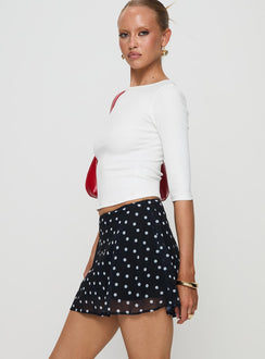   side view of model wearing Princess Polly Dapple Bias Mini Skirt Black Polka Dot Mini Skirts Skirts 