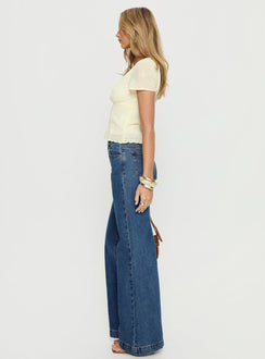 side view of model wearing Princess Polly Goldie High Rise Wide Leg Jeans Mid Blue Wash High Rise Jeans 