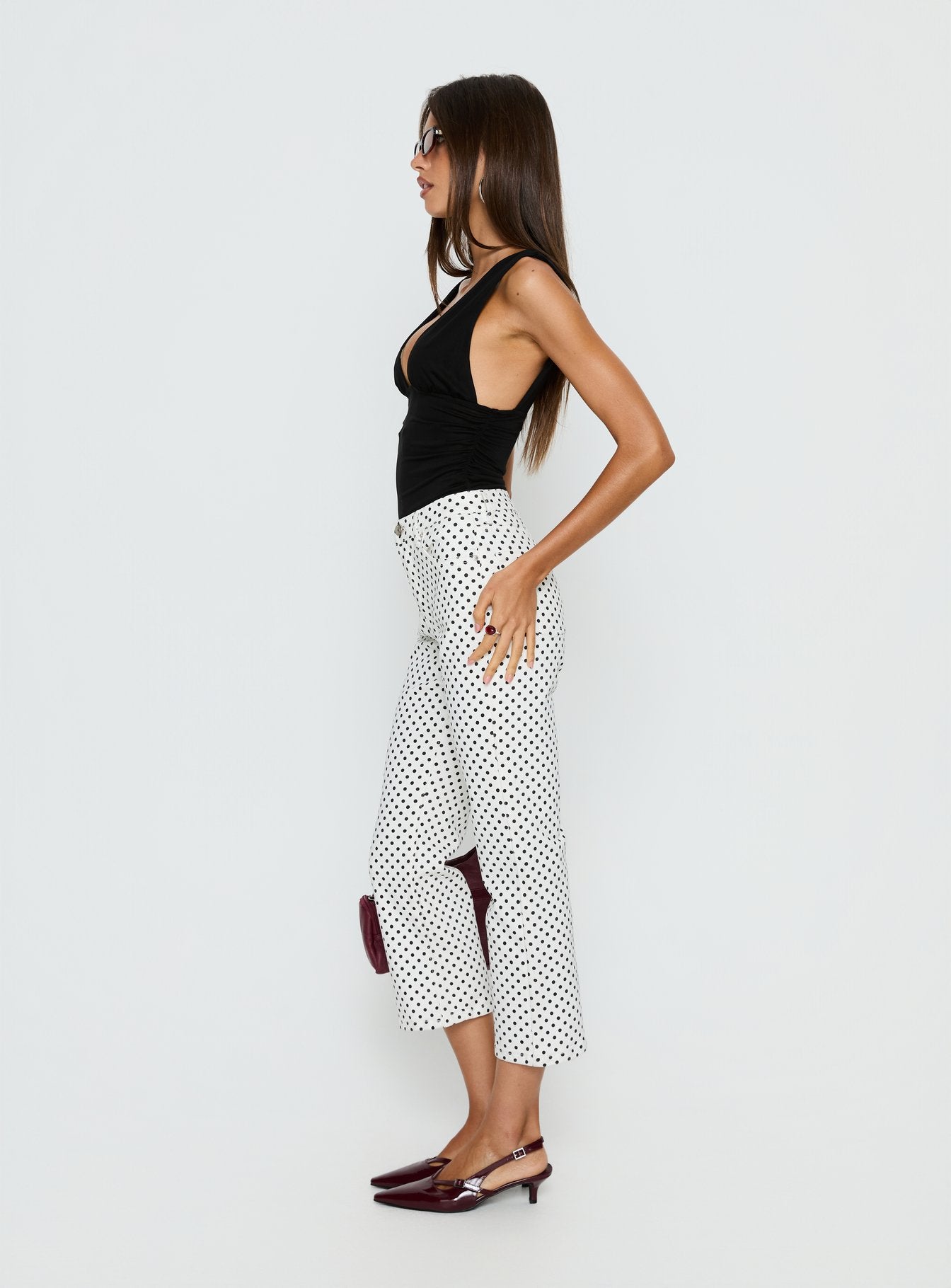 side view of model wearing Princess Polly Cindee High Rise Cropped Jeans White Polka Dot High Rise Jeans 