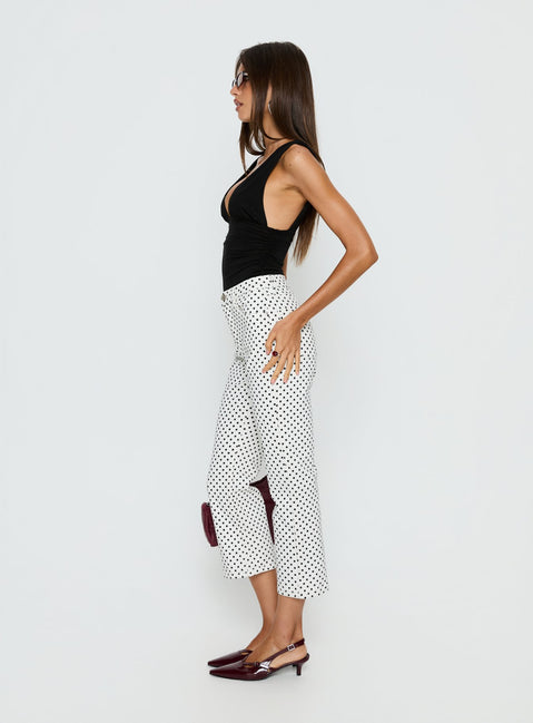 side view of model wearing Princess Polly Cindee High Rise Cropped Jeans White Polka Dot High Rise Jeans 