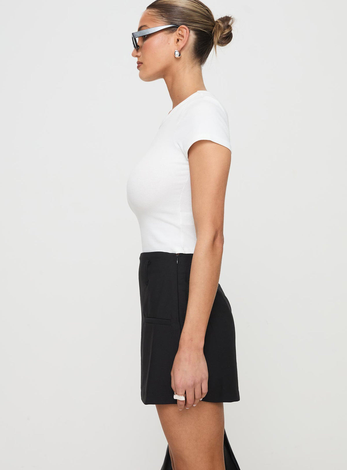 side view of model wearing Princess Polly Grant My Wish Mini Skort Black High Waisted Shorts 