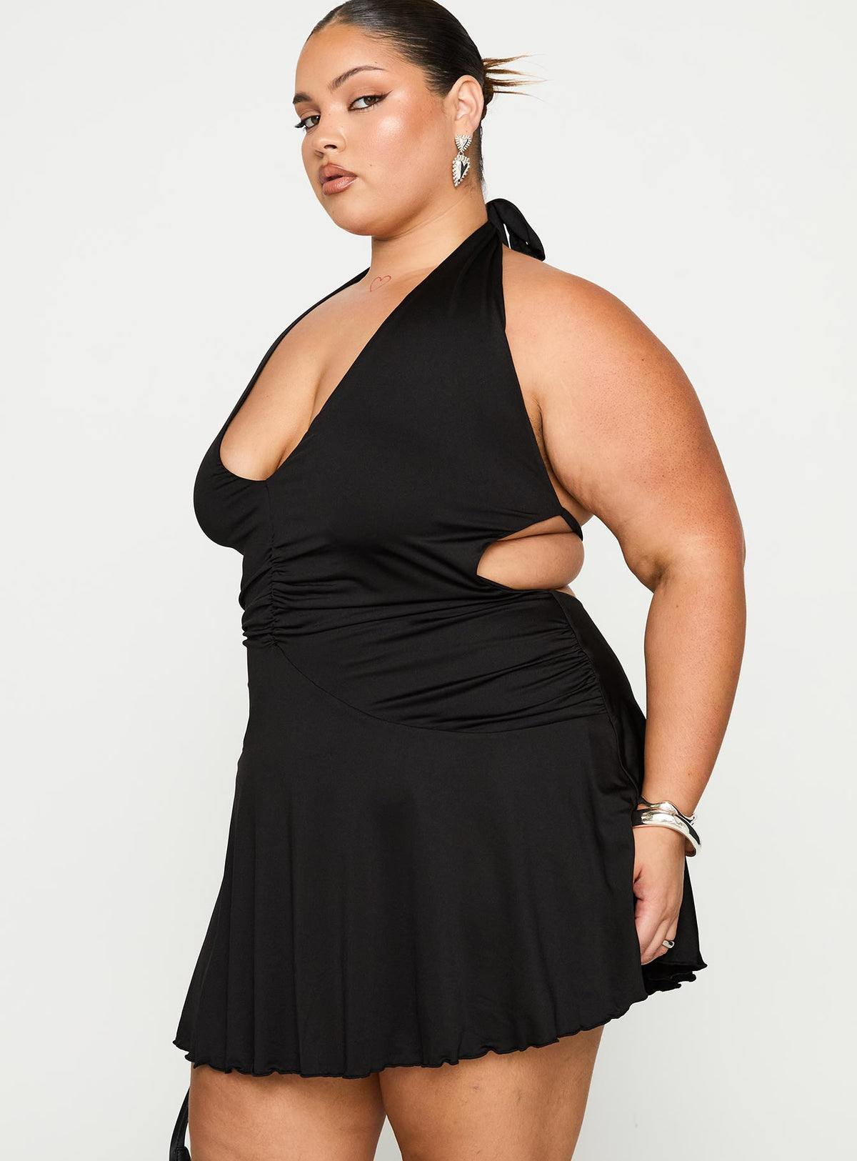 side view of model wearing Princess Polly Maeva Halter Mini Dress Black Curve Plunger 