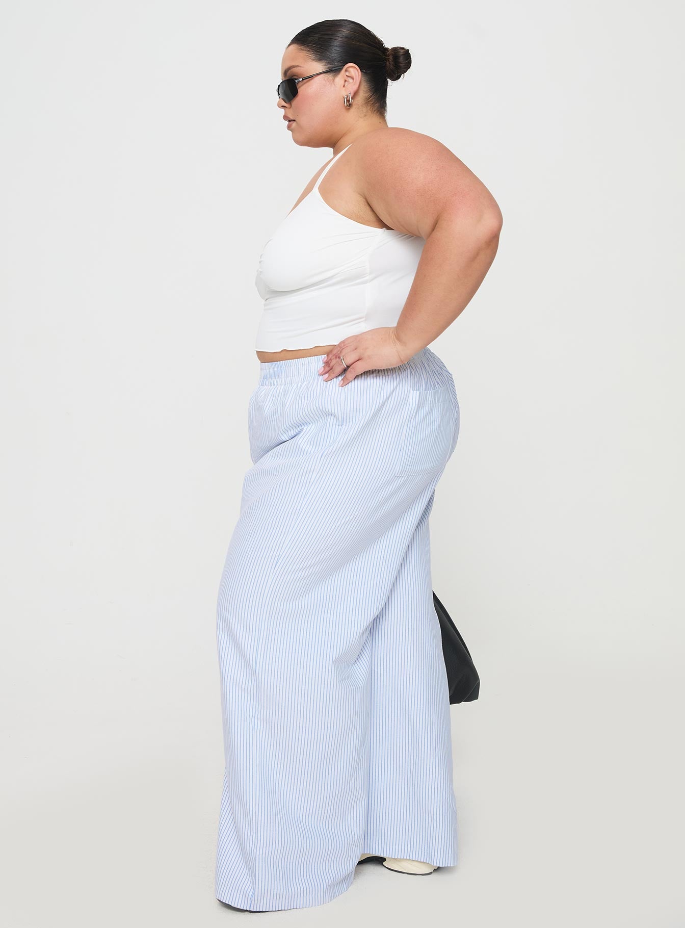 side view of model wearing Princess Polly Beach House Pants Blue Stripe Curve Pants 