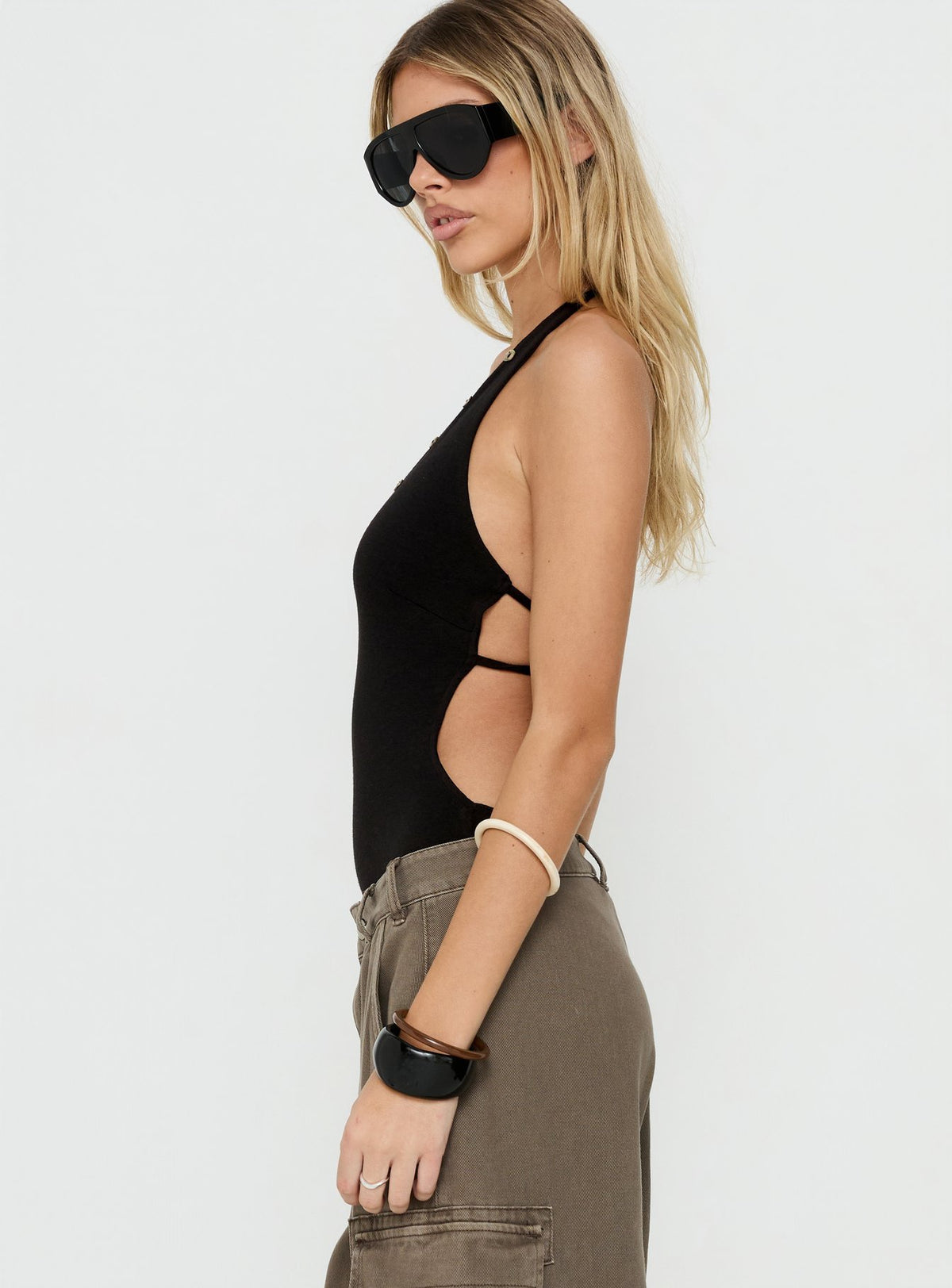 Shop the Cacilie Plunge Shell Bodysuit Black womens-bodysuit crafted with sleeveless construction side view of model wearing Princess Polly