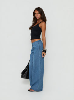Highlighting the Hereos Mid Rise Baggy Leg Jeans in Bright Blue Wash, womens jeans featuring mid-rise waist and belt, side view of model wearing Princess Polly