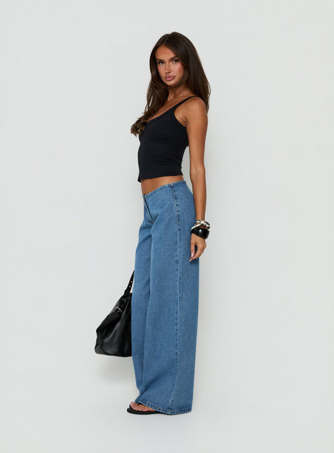 Highlighting the Hereos Mid Rise Baggy Leg Jeans in Bright Blue Wash, womens jeans featuring mid-rise waist and belt, side view of model wearing Princess Polly