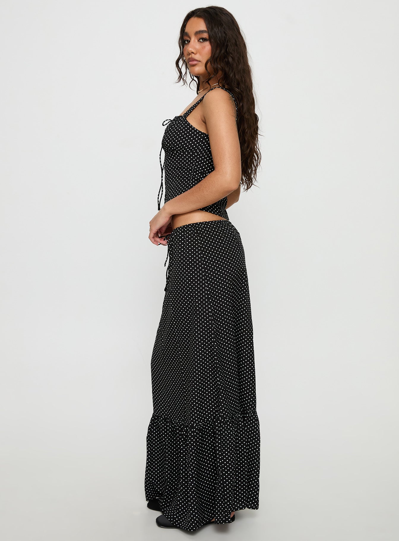   side view of model wearing Princess Polly Modern Girl Maxi Skirt Black / Polka Dot Skirts 