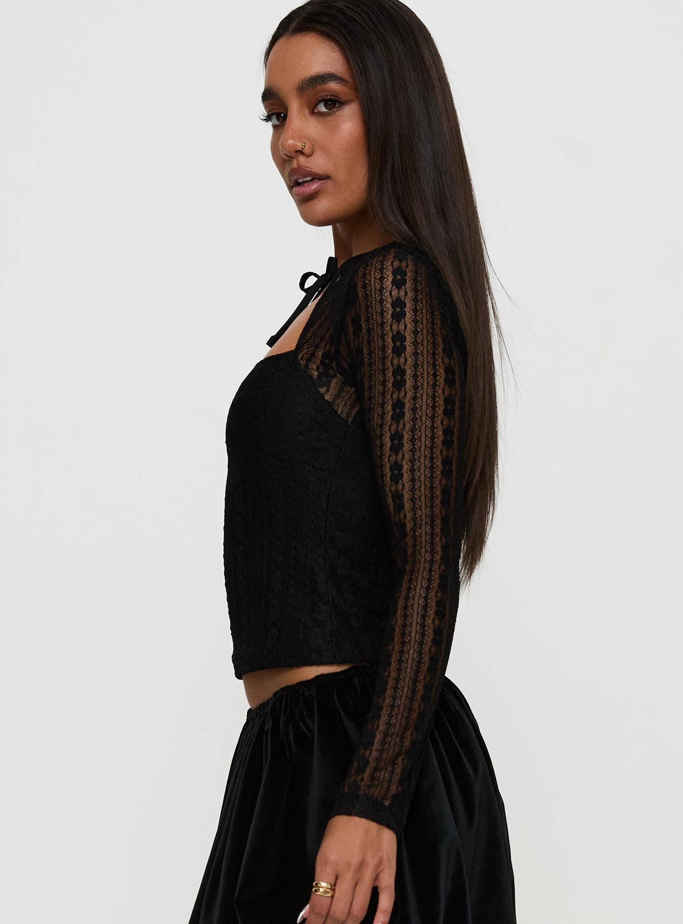 side view of model wearing Princess Polly Worth My Time Tie Neck Cut Out Top Black Full Sleeves High Neck 