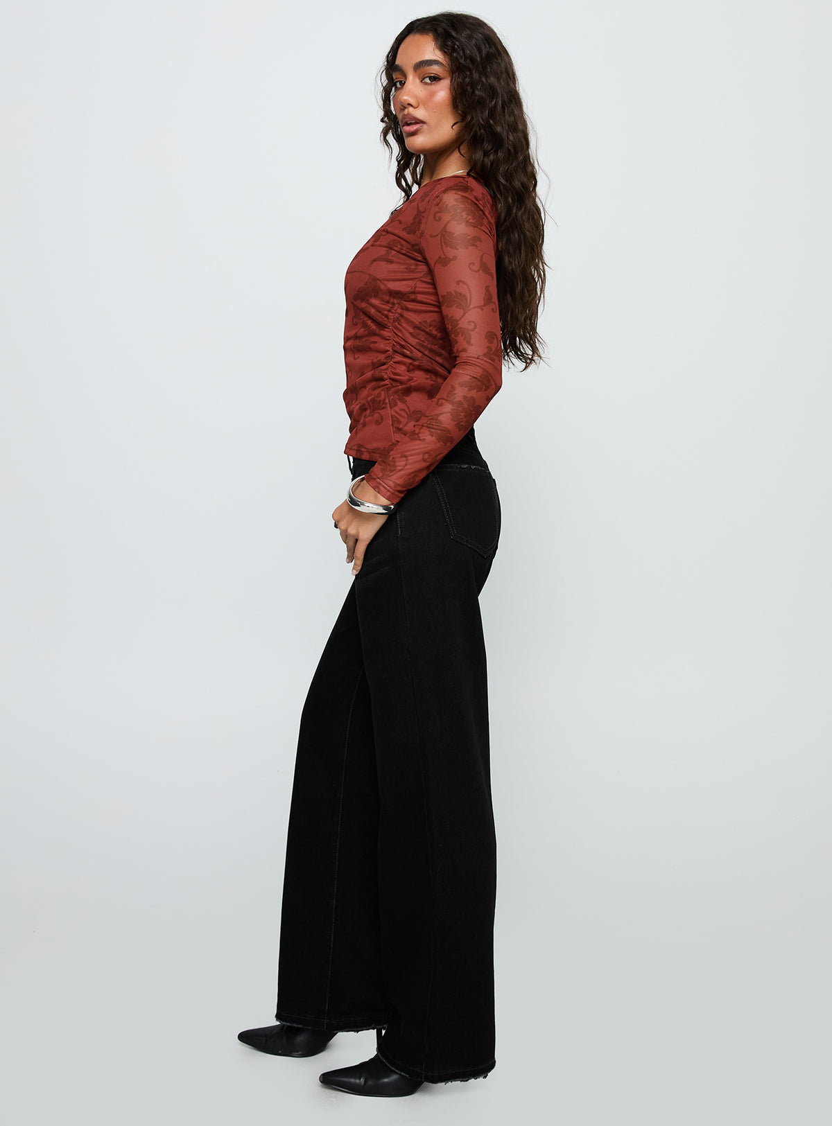 side view of model wearing Princess Polly West End Girl Mid Rise Straight Leg Jeans Washed Black Mid Rise Jeans 