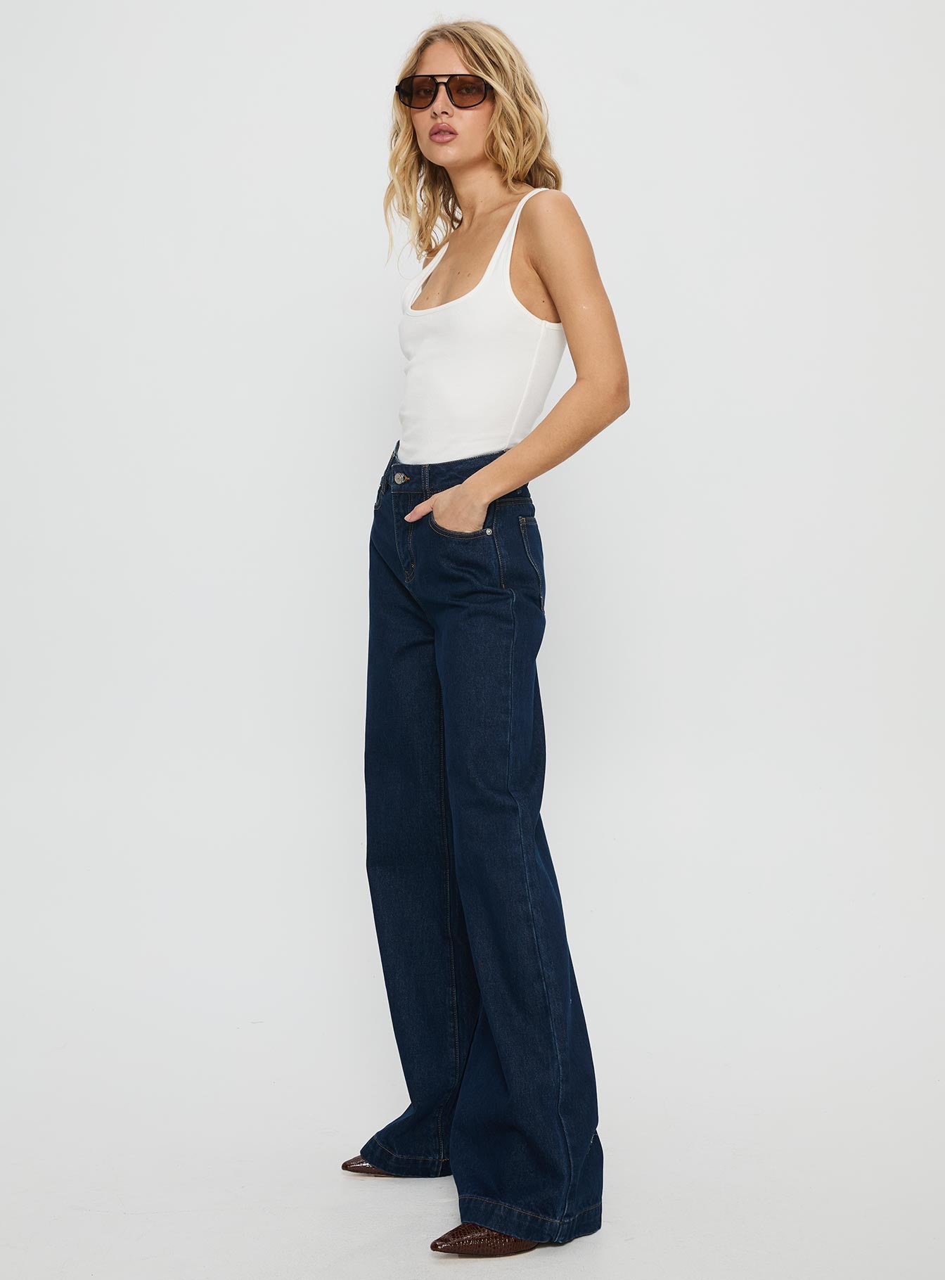 side view of model wearing Princess Polly Goldie High Rise Wide Leg Jeans Indigo High Rise Jeans 