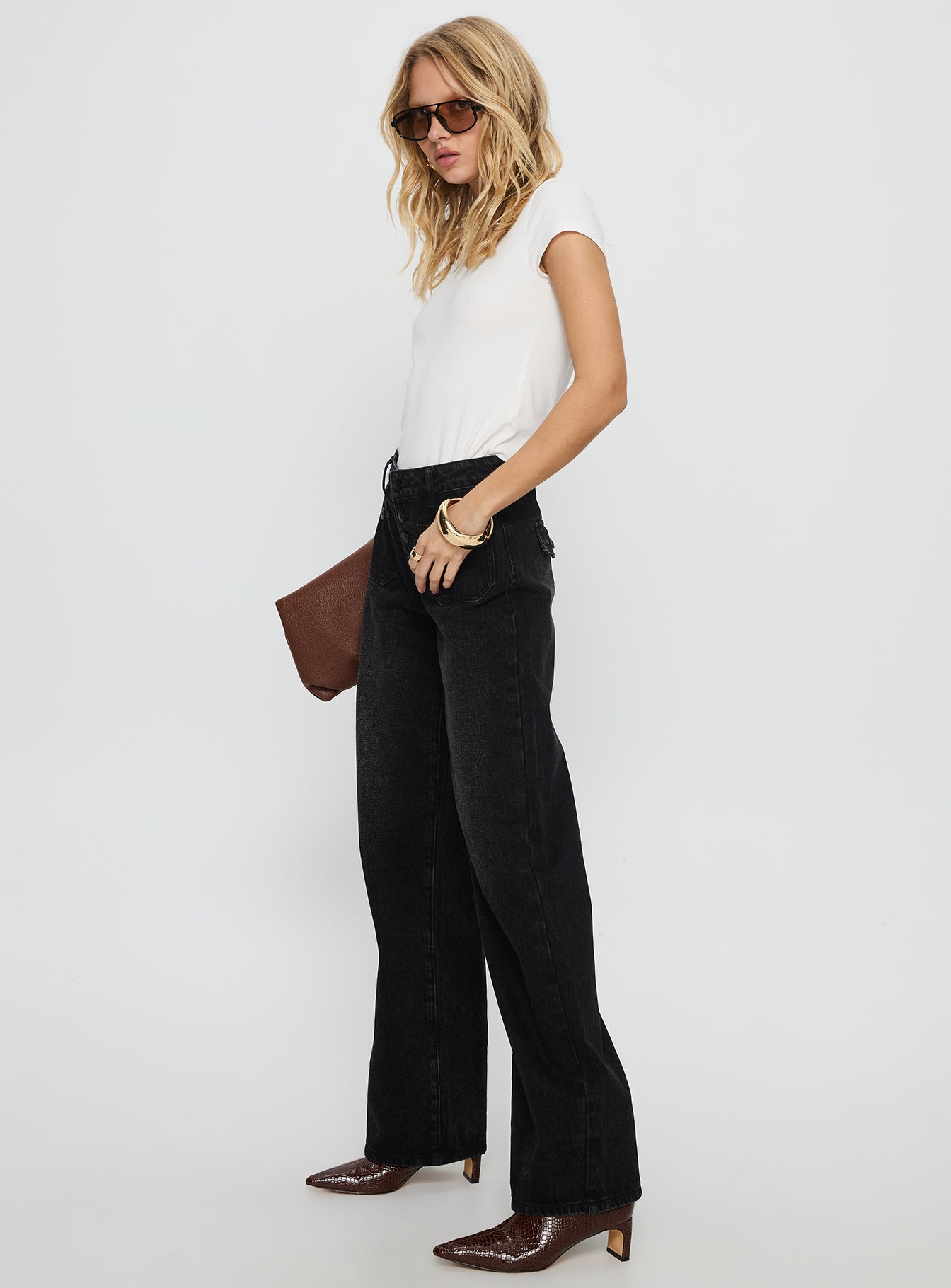 side view of model wearing Princess Polly Carianne Low Rise Wide Leg Jeans Washed Black Mid Rise Jeans 