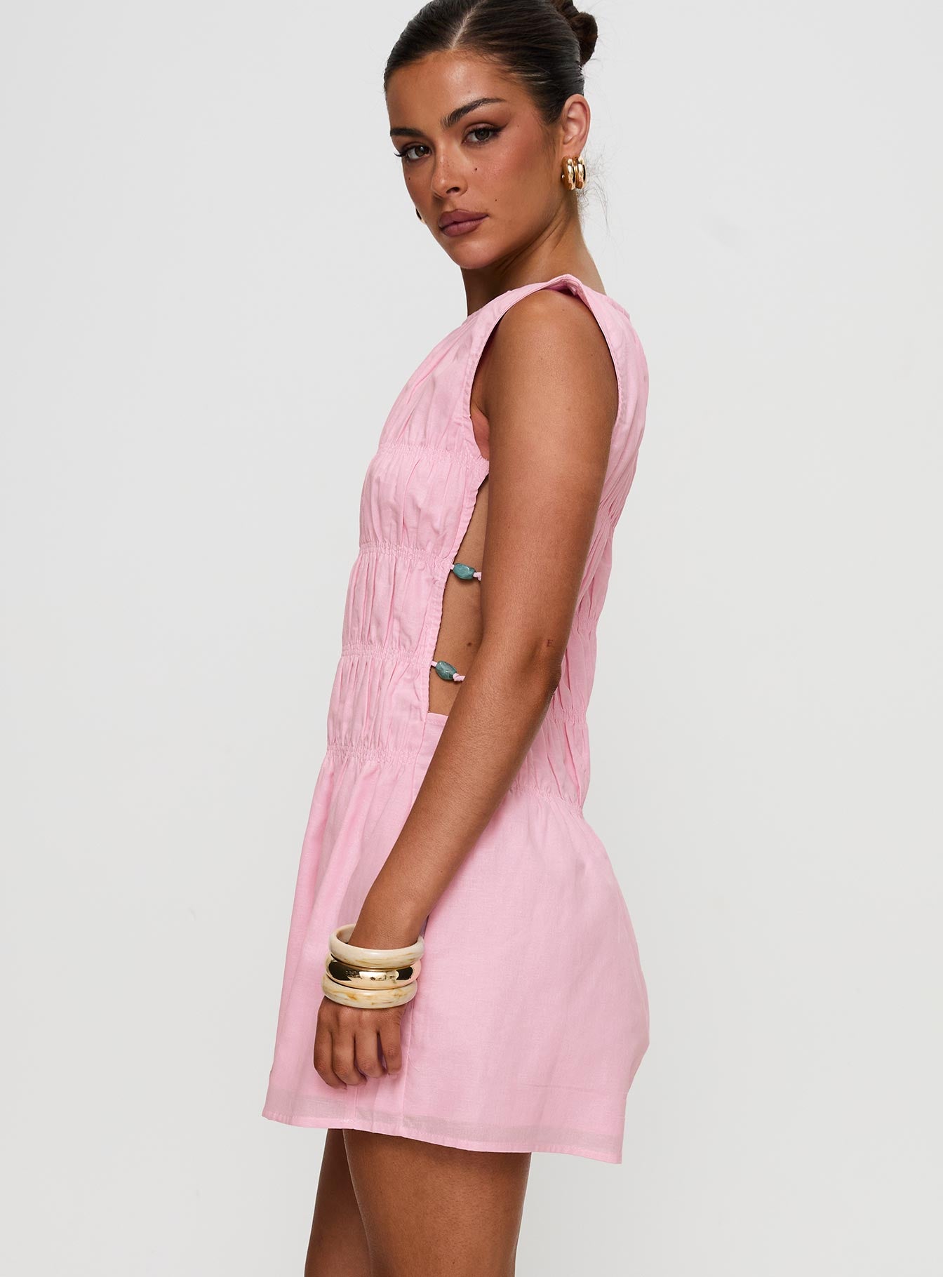 side view of model wearing Princess Polly Evony Shirred Mini Dress Pink Crew Neck 