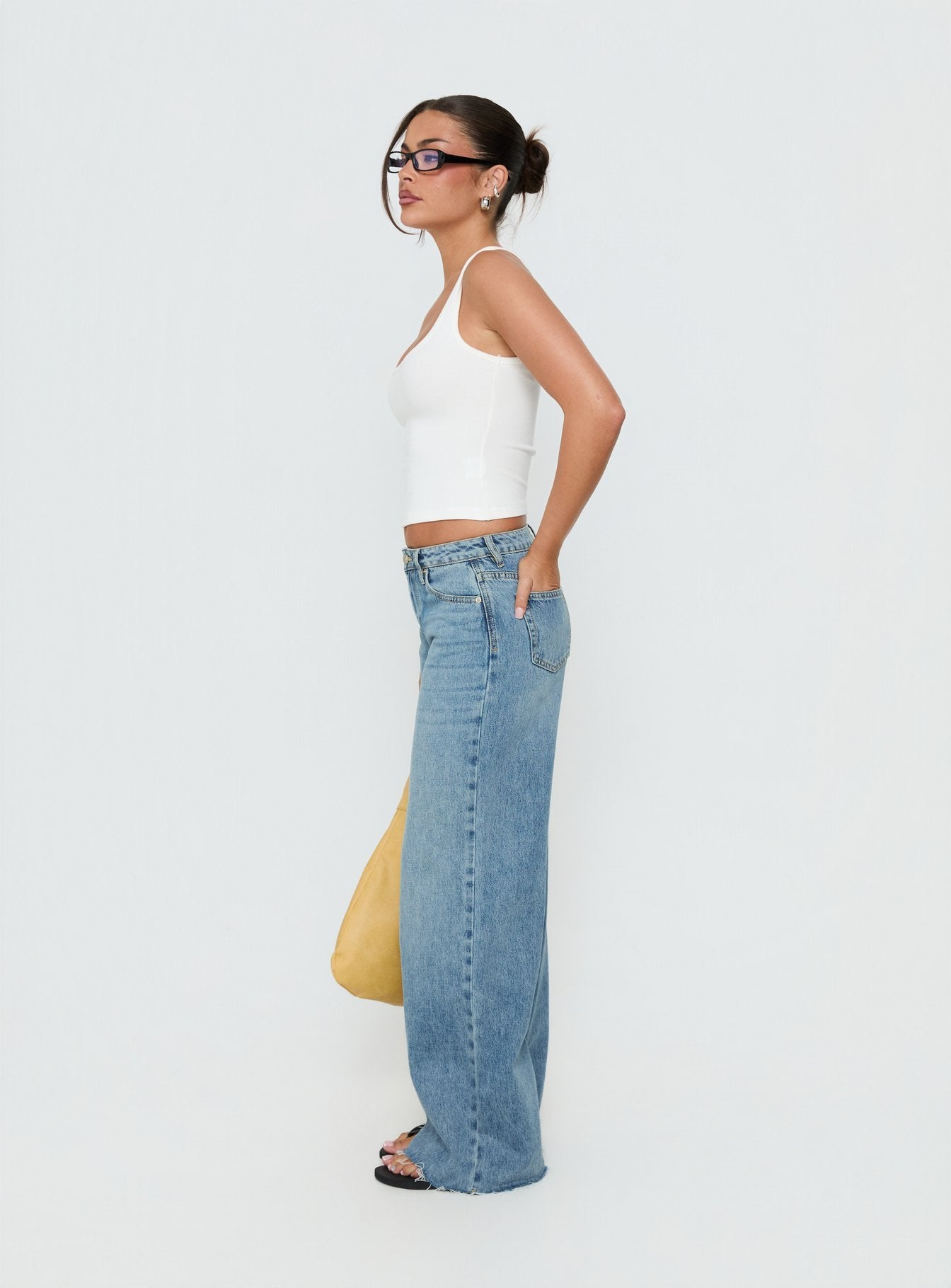 Designed with the Darla Low Rise Straight Leg Jean in Vintage Light Blue as womens jeans with low-rise side view of model wearing Princess Polly