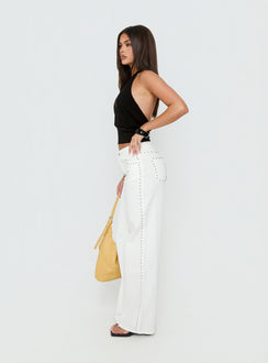 Showcasing the Saving Up Mid Rise Straight Leg Studded Jeans White in womens-jeans with silver studs side view of model wearing Princess Polly