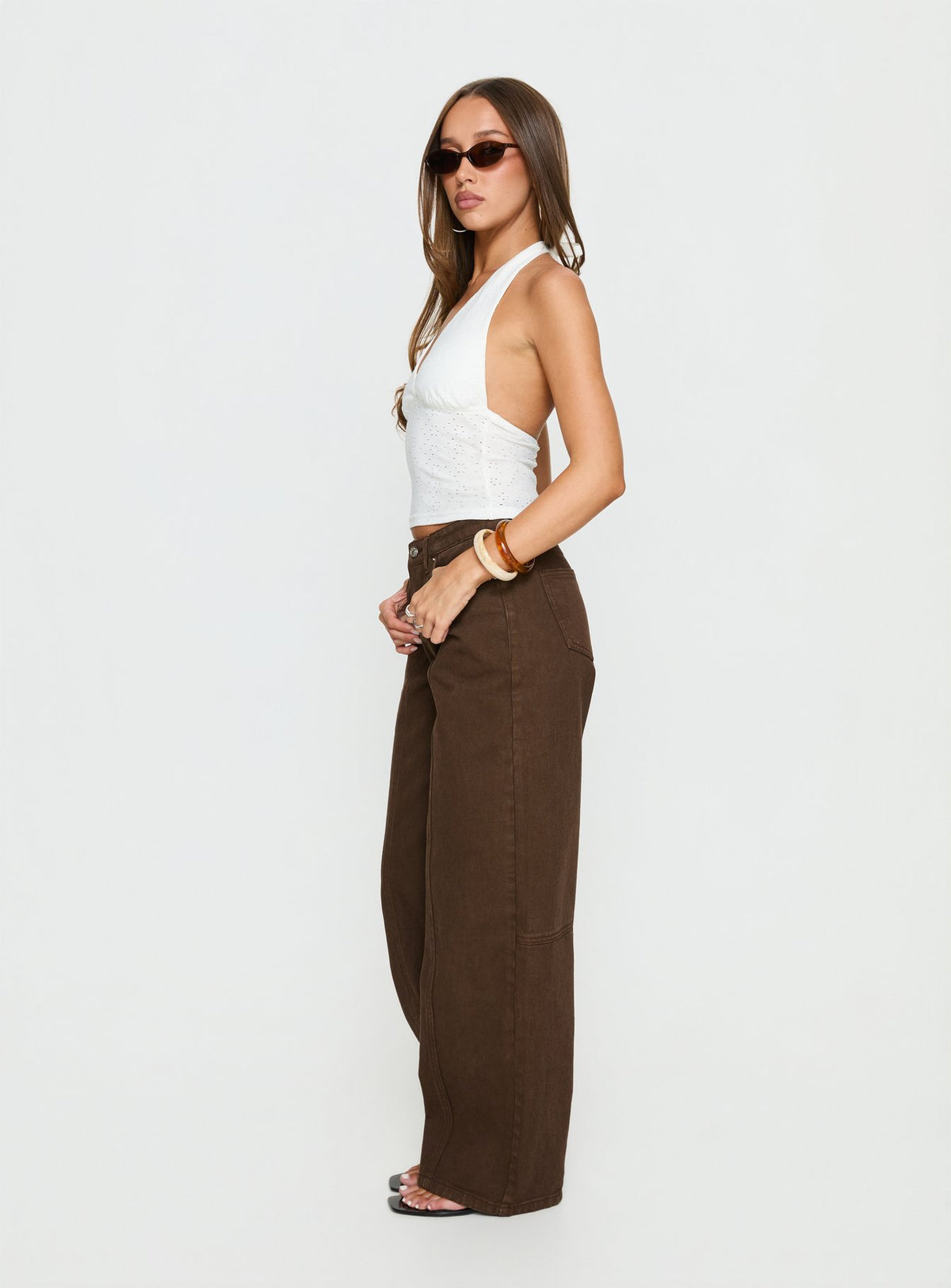 side view of model wearing Princess Polly Lando Low Rise Straight Leg Jeans Chocolate Mid Rise Jeans 