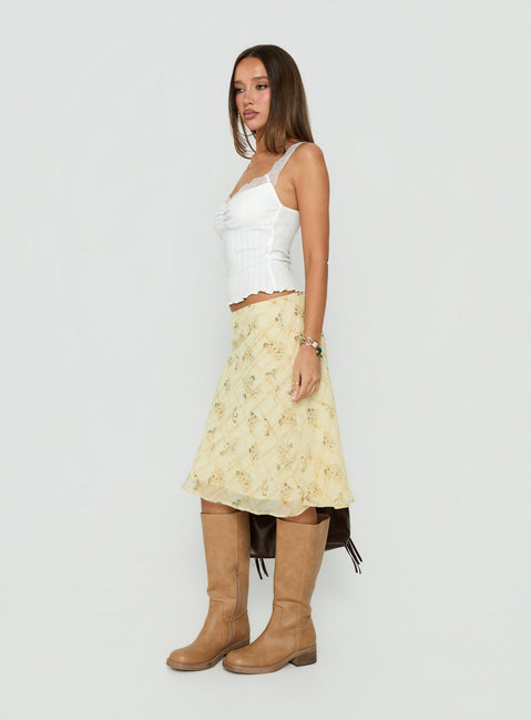 Showcasing the Evina Picot Trim Midi Skirt Yellow Paisley womens-skirts with a-line shape, frill details, fitted silhouette, frayed hem, and midi length side view of model wearing Princess Polly