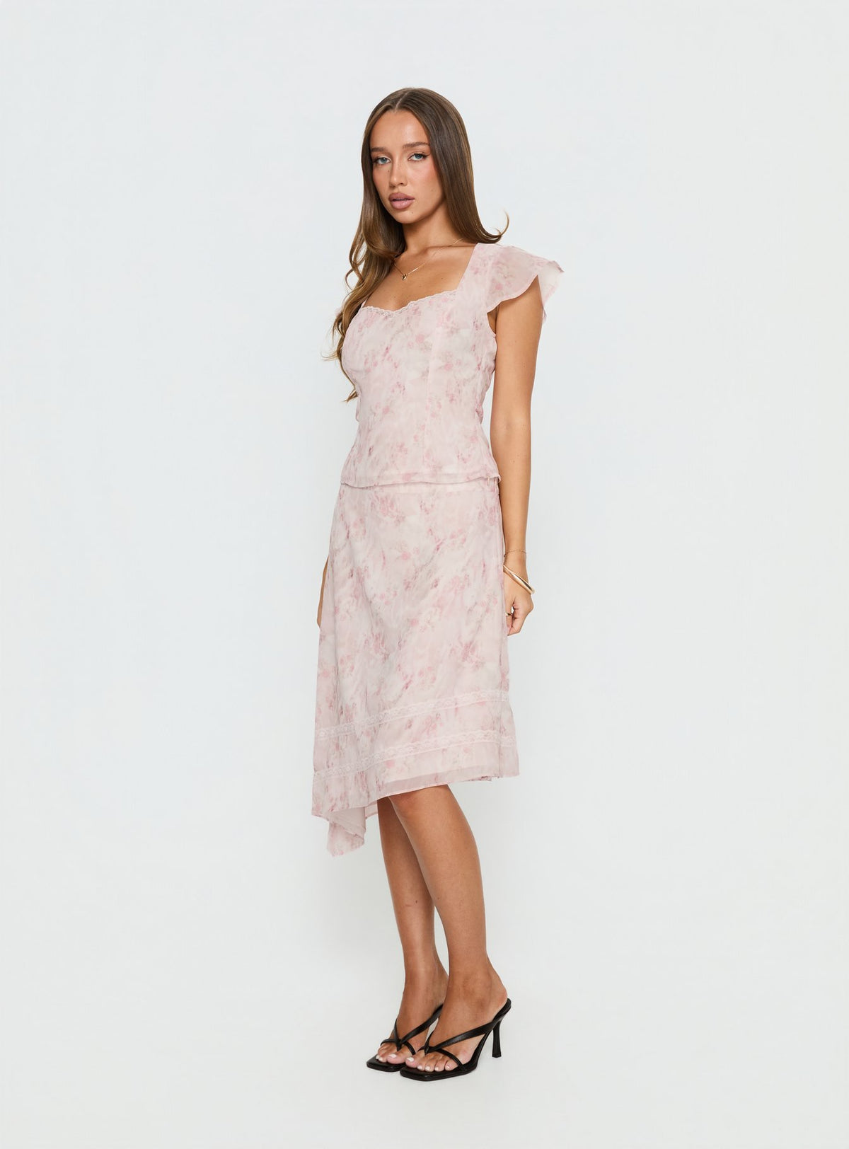   side view of model wearing Princess Polly Avaline Asymmetrical Midi Skirt Pink 