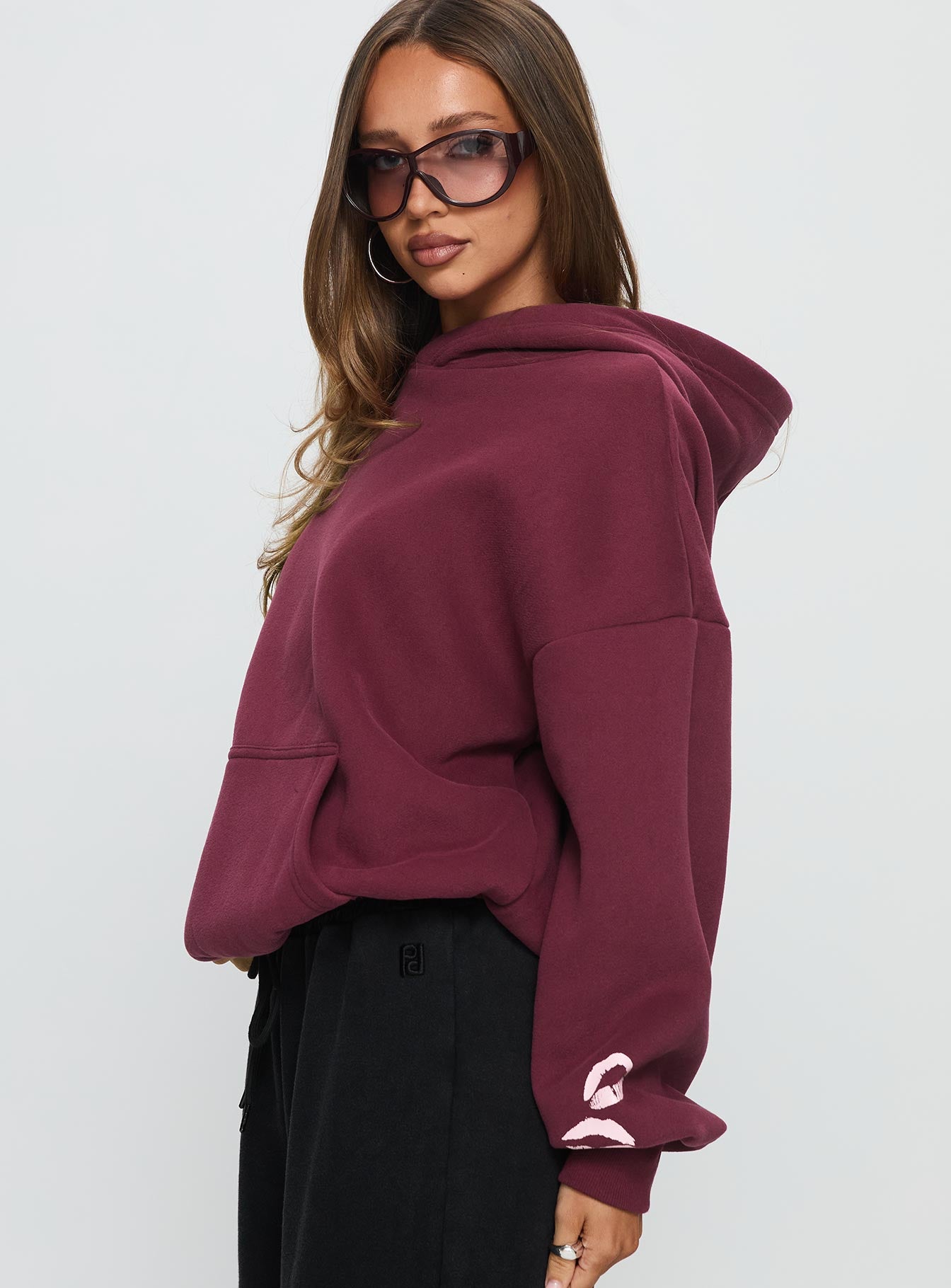 side view of model wearing Princess Polly Kisses Graphic Hoodie Wine Longline Jumpers Jumpers 