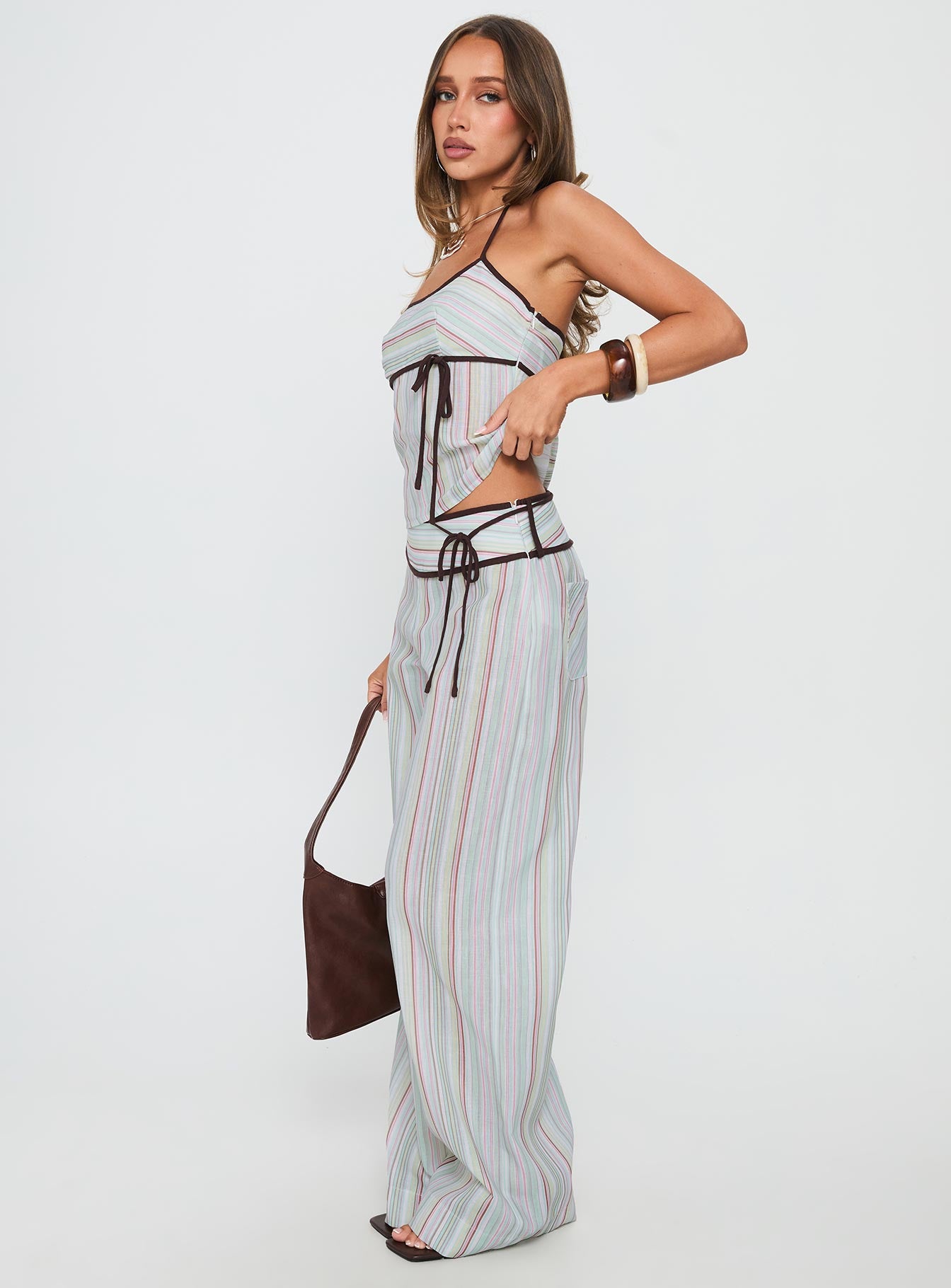 side view of model wearing Princess Polly Taylar Thick Waistband Tie Pants Green Stripe High Waisted Pants 