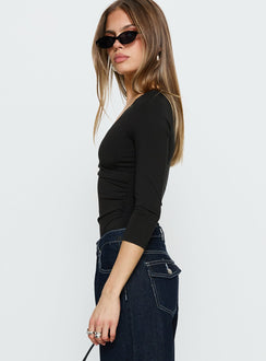 side view of model wearing Princess Polly Lyselle Wrap Detail 3/4 Sleeve Bodysuit Black Quarter Sleeve 