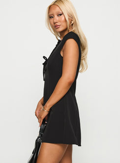 side view of model wearing Princess Polly Adeleine Bow Mini Dress Black Crew Neck 