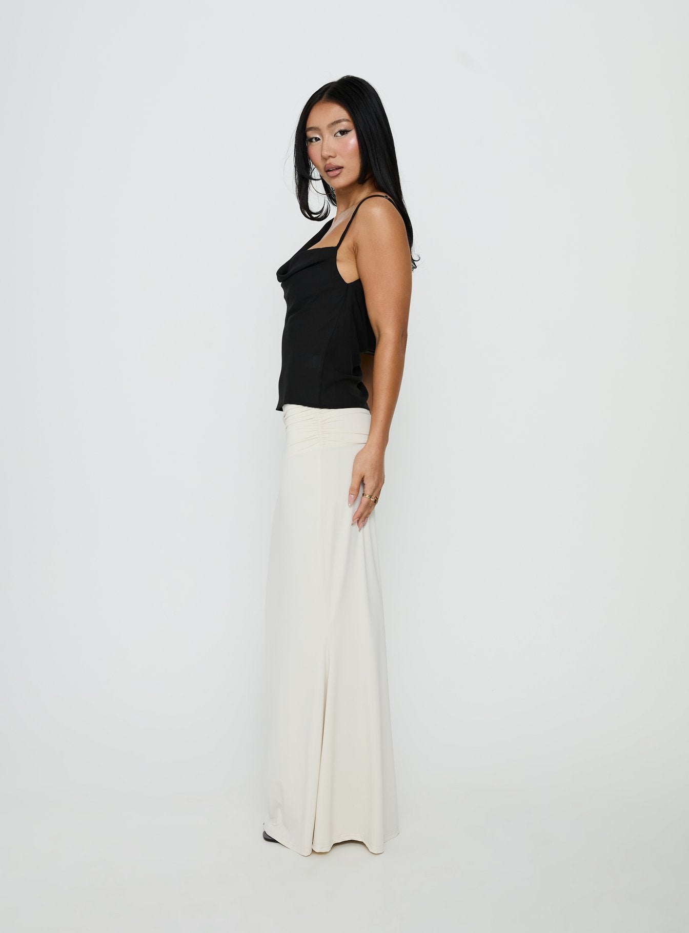 Designed with the Liorah Foldover Waist Maxi Skirt Cream in womens-skirts featuring maxi length side view of model wearing Princess Polly