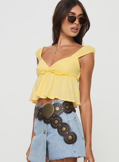 side view of model wearing Princess Polly Contardo Short Sleeve Top Yellow Short Sleeves Plunger 