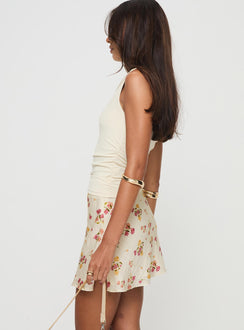   side view of model wearing Princess Polly Sonnet Mini Skirt Cream / Multi Floral Mini Skirts 