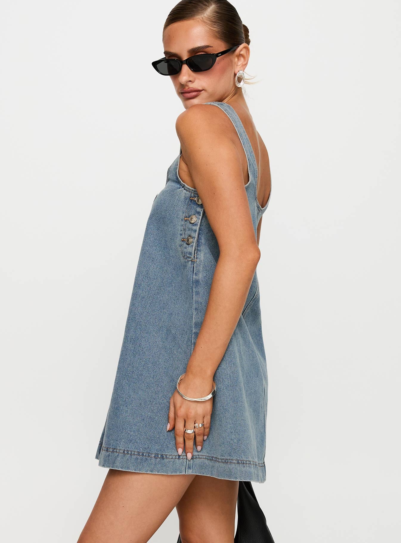 side view of model wearing Princess Polly State Of Mind Mini Dress Blue Denim Scoop Neck 