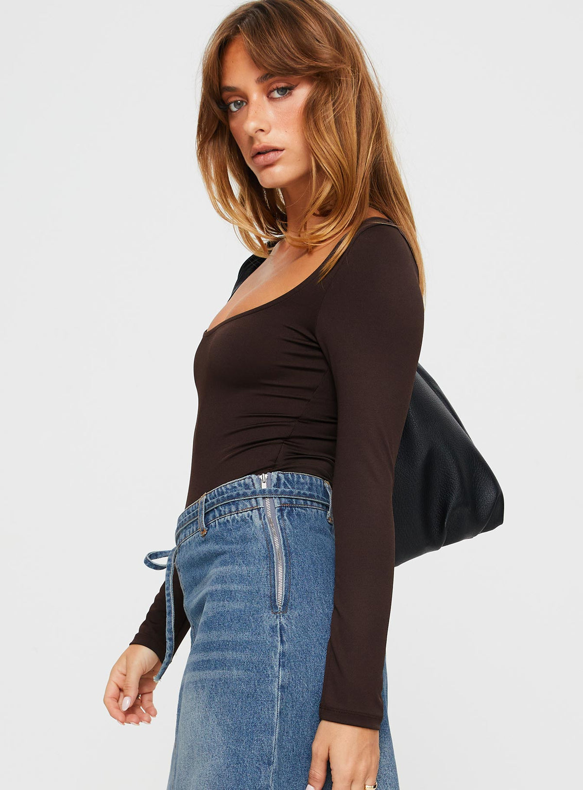 side view of model wearing Princess Polly Ellery Bodysuit Brown Tall Full Sleeves 