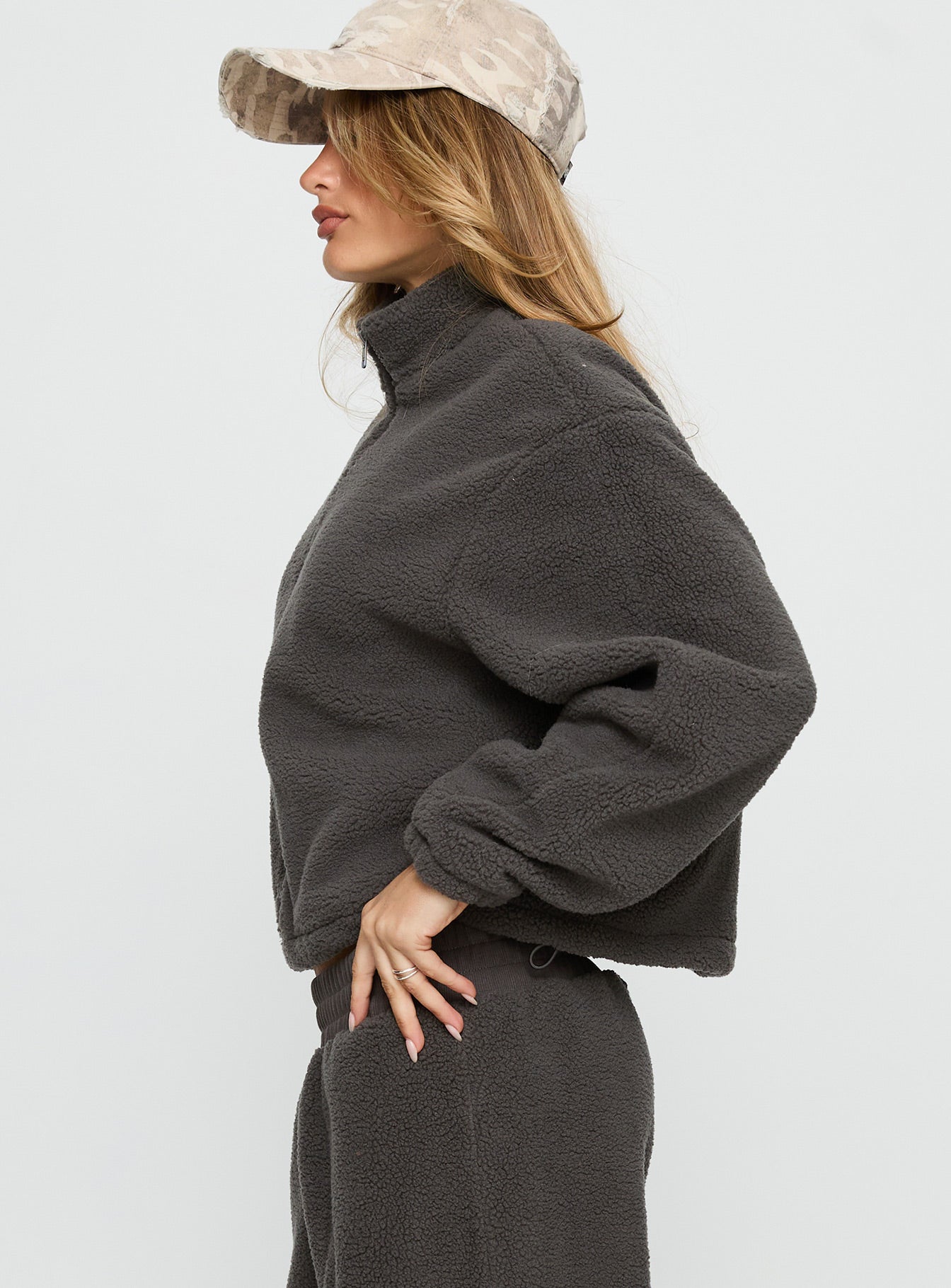 side view of model wearing Princess Polly Siberia Fleece Zip Up Jumper Charcoal regular 