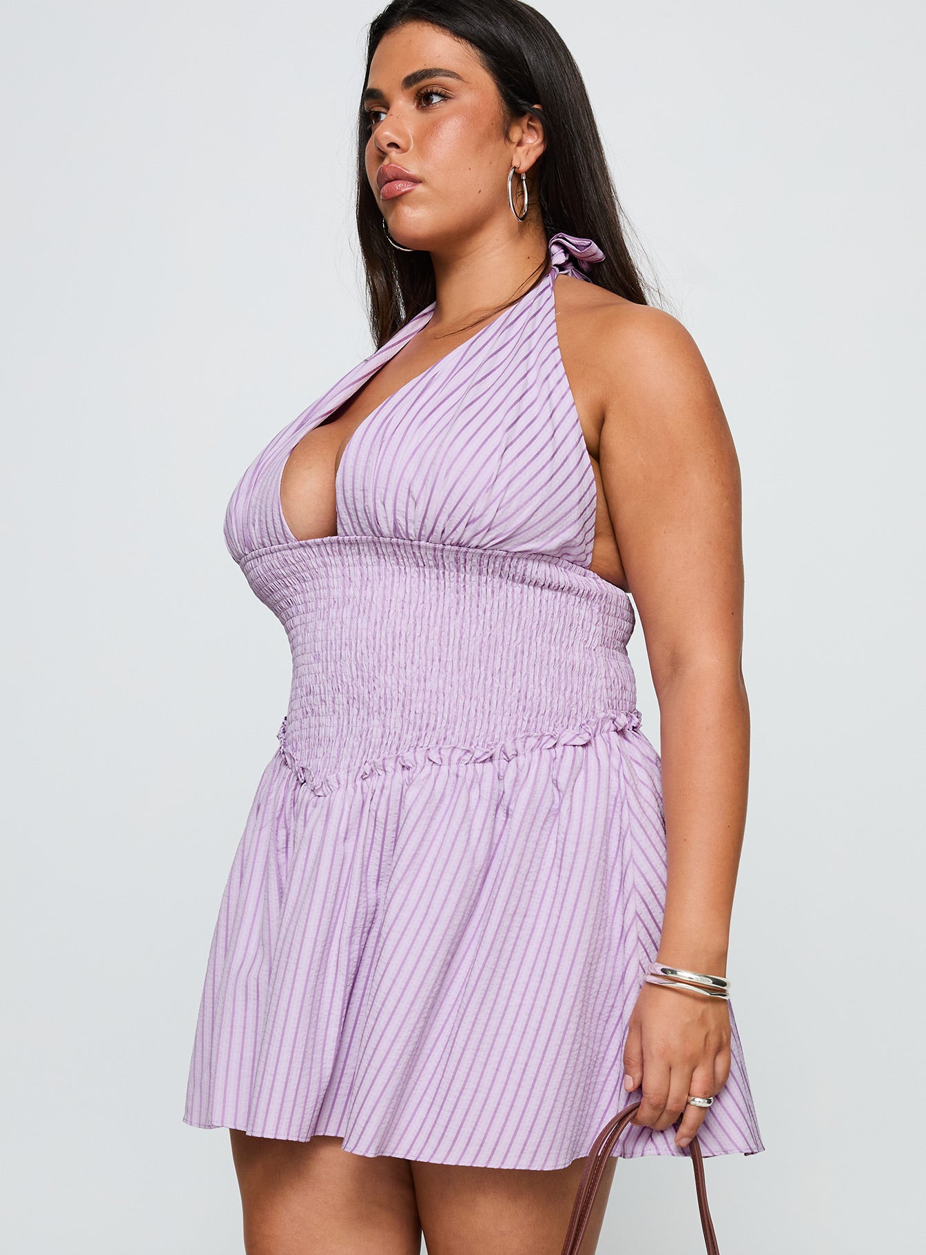 side view of model wearing Princess Polly Attracted Halter Mini Dress Purple Stripe Curve Plunger 