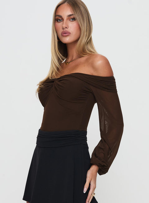 Crafted with ruched detailing, the Babette Off The Shoulder Bodysuit in Brown womens-bodysuit showcases full sleeves detail view of model wearing